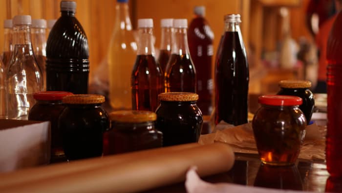 Bottles of homemade mead, along with jars of honey.