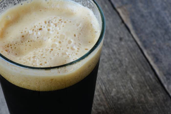 Closeup of a glass of dark beer.