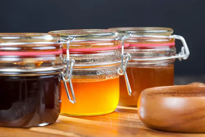 Jars of different-colored honey. Honey is one ingredient that will influence the answer to the question: What does mead taste like?