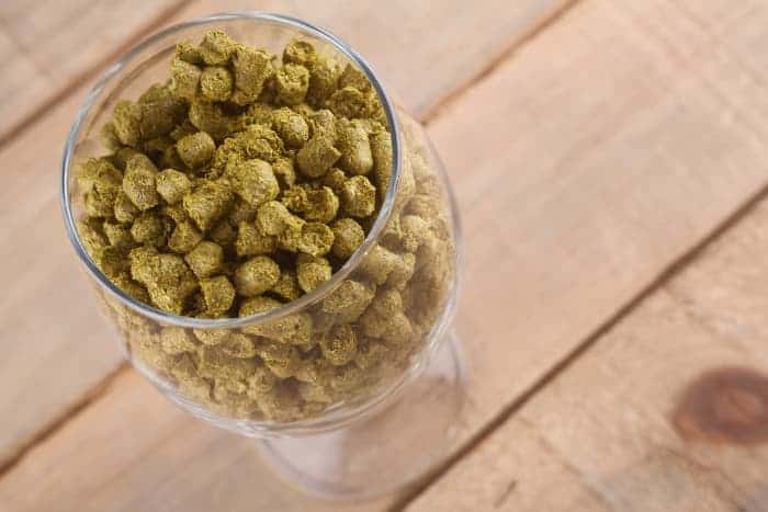 Overhead view of a glass of hops pellets.