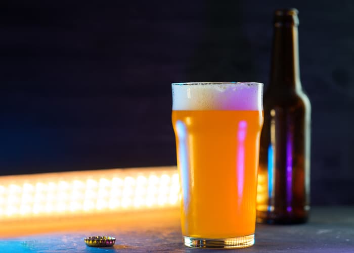 A pint glass of pale ale beer.