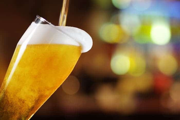 Draft beer being poured into glass.