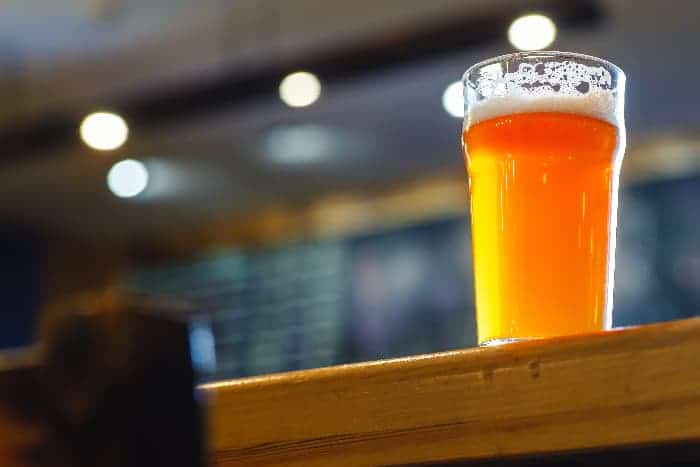 Pint glass of pale ale on a bar counter. Citra hops is used to make pale ale, IPA, and Double IPA beer.