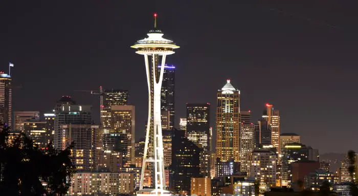 Seattle city skyline at night with Space Needle in foreground.