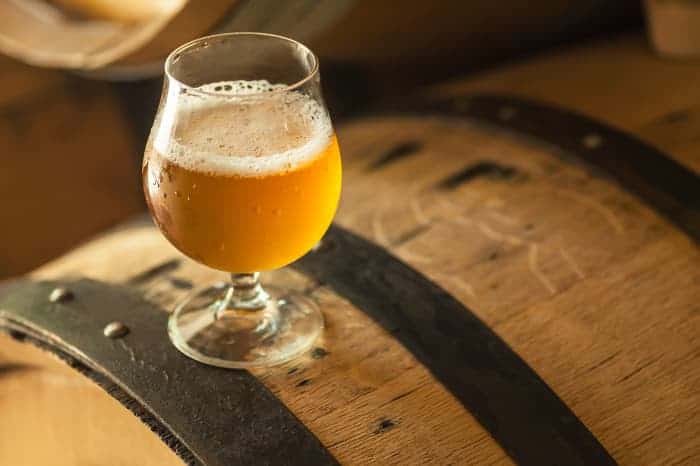 A goblet of pale colored beer.