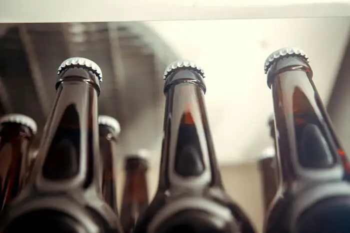 Brown glass beer bottles in a fridge.