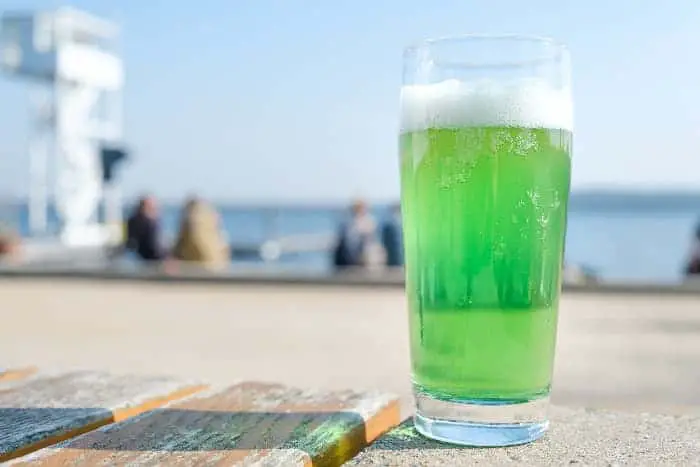 A glass of Berliner Weiss beer that's green in color.