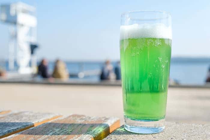 A glass of Berliner Weiss beer that's green in color.