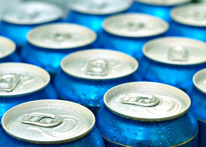 View of tops of beer or soda cans.