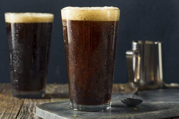 Pint glasses of coffee porter and coffee stout beer.