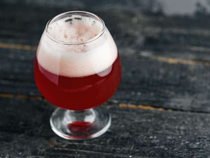 A goblet of craft cherry fruit beer.