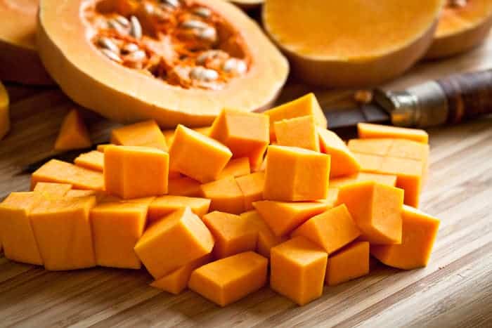 Cubed pumpkin meat on a board.