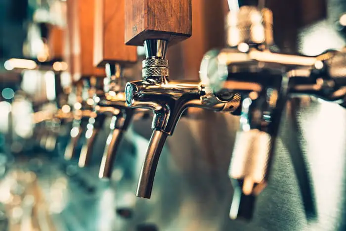 Closeup of draft beer taps.