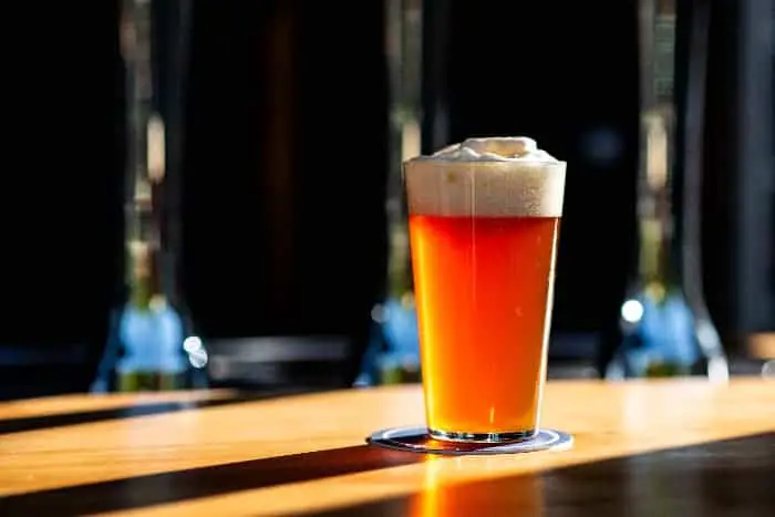 A pint glass of coppery-colored beer.