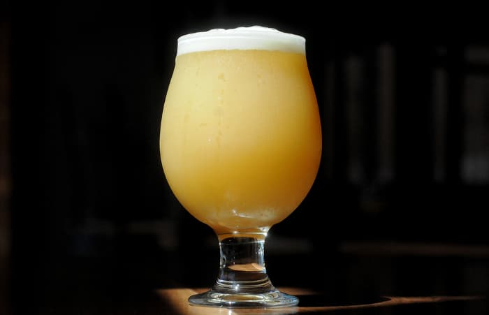 A large goblet of hazy craft beer.