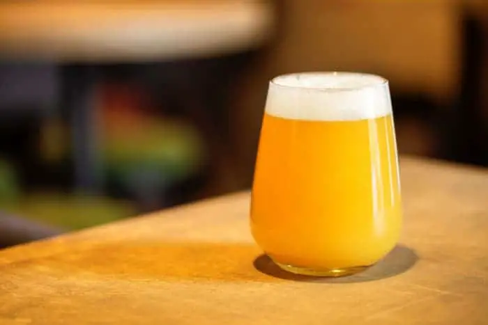 A glass of hazy IPA beer.