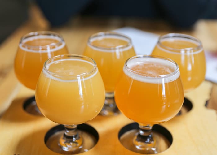 Goblets of craft hazy IPA beer.