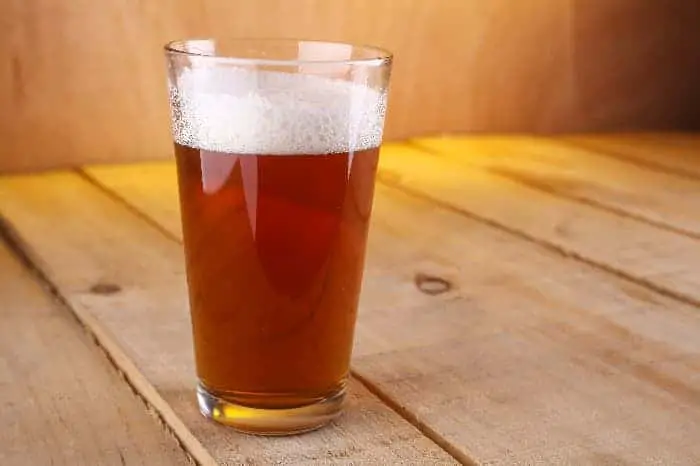 A pint glass of amber-colored beer.