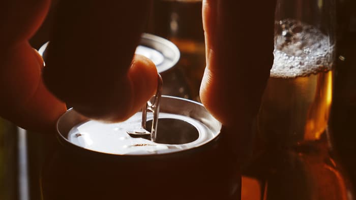 Person opening can of beer.