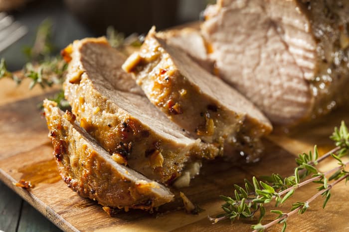 Closeup of roast pork tenderloin, a perfect meal pairing for New England IPA beer.