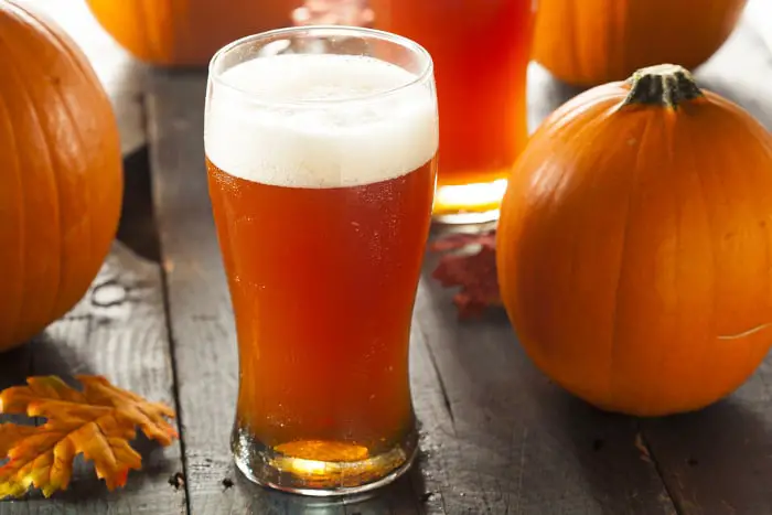 Glass of orange-colored pumpkin ale.