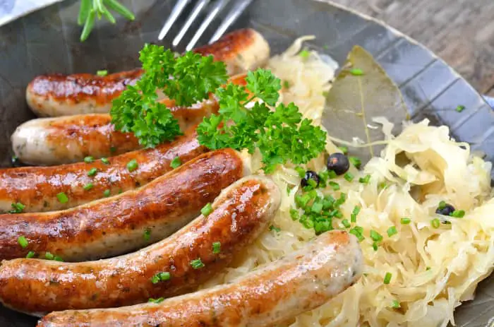 A meal of smoked sausages and sauerkraut that would pair nicely with Belgian dubbel beer.