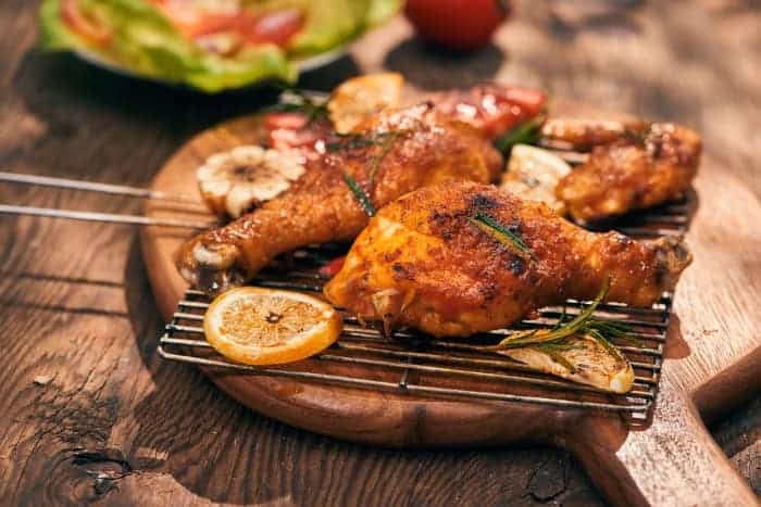 Barbecue chicken legs and herbs.