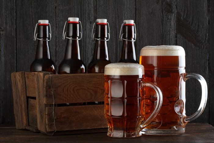 Craft beer in bottles and beer mugs.