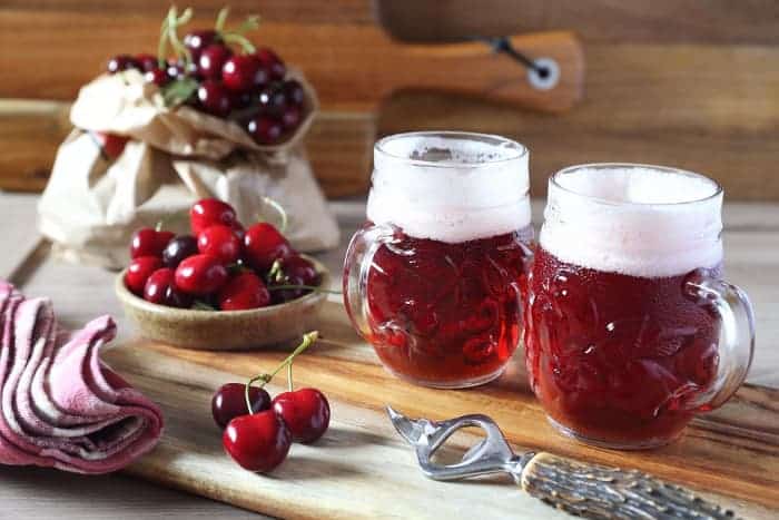 Mugs of cherry fruit beer.