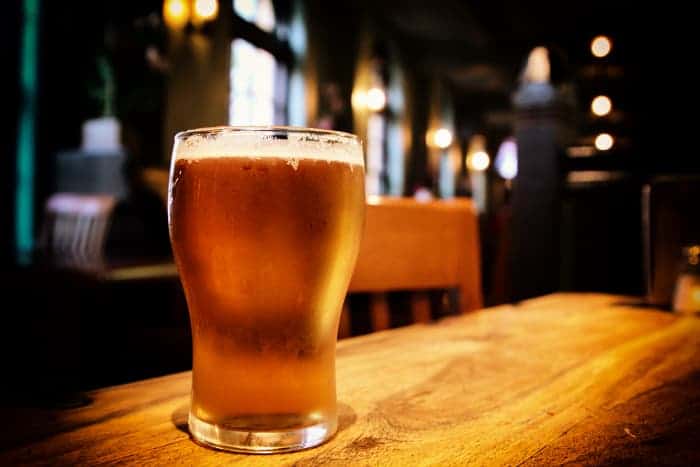 A pint glass of coppery-colored beer.