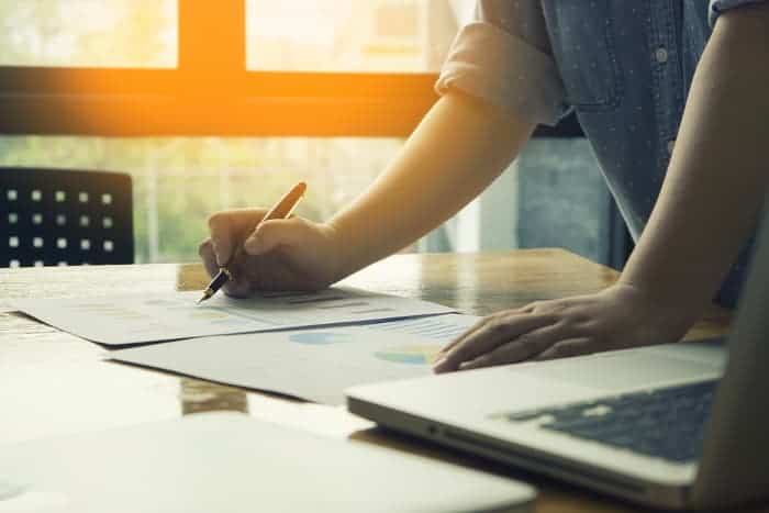Person working on business plan paperwork.
