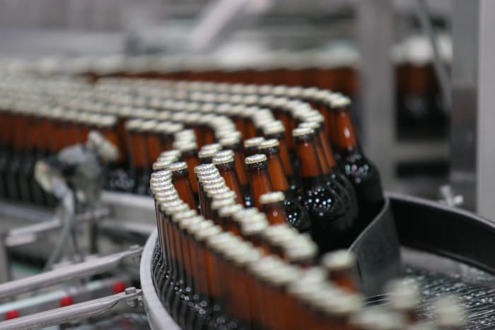 A conveyor belt of mass produced bottled beer.