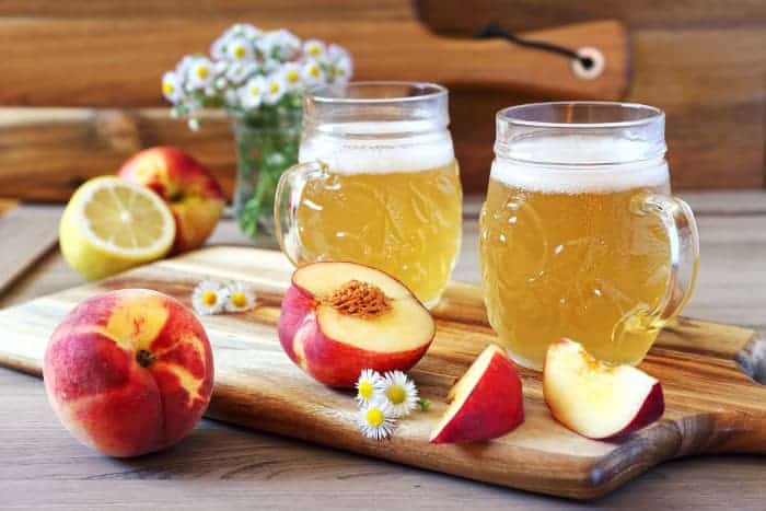Mugs of lemon and apricot fruit beer.