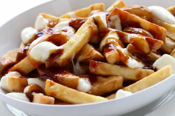 Closeup of poutine -- a dish of fries with gravy and cheese.
