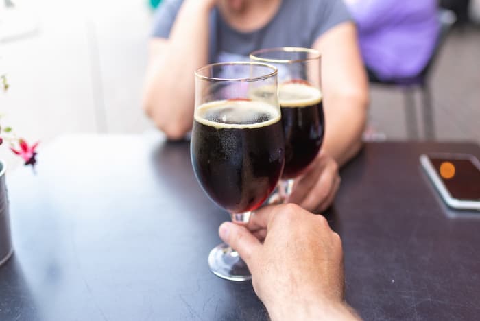 A man and a woman enjoying beer at a pub