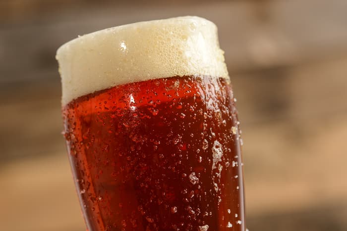 Closeup of a reddish-colored beer, similar to rye beer.